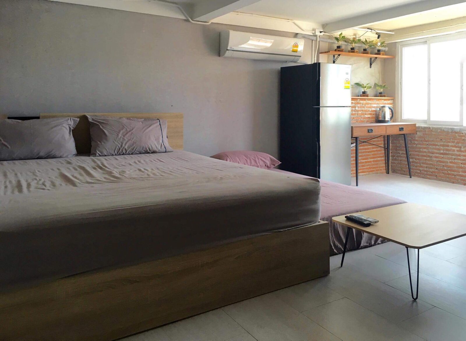 Rooftop Apartment bedroom with a double bed and kitchenette